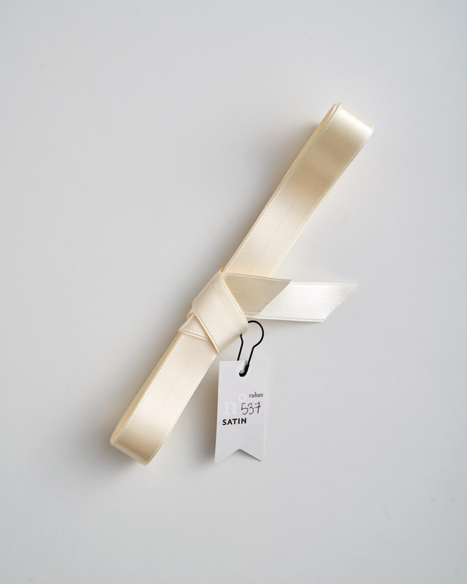 cream ribbon in roll on white Stock Photo