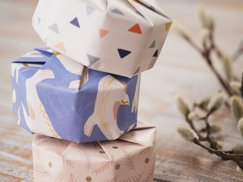 3 piled gifts with Impression Originale recycled and original design gift wraps