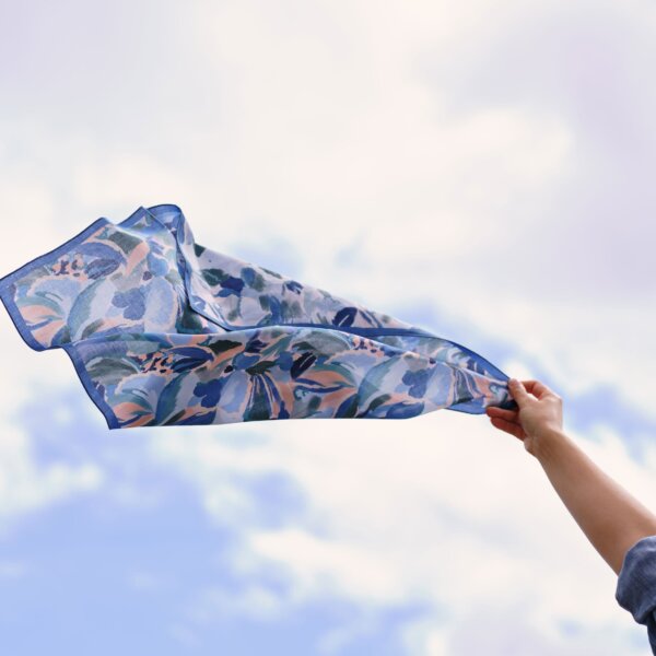Carnaval Furoshiki floating against a cloudy sky by Impression Originale