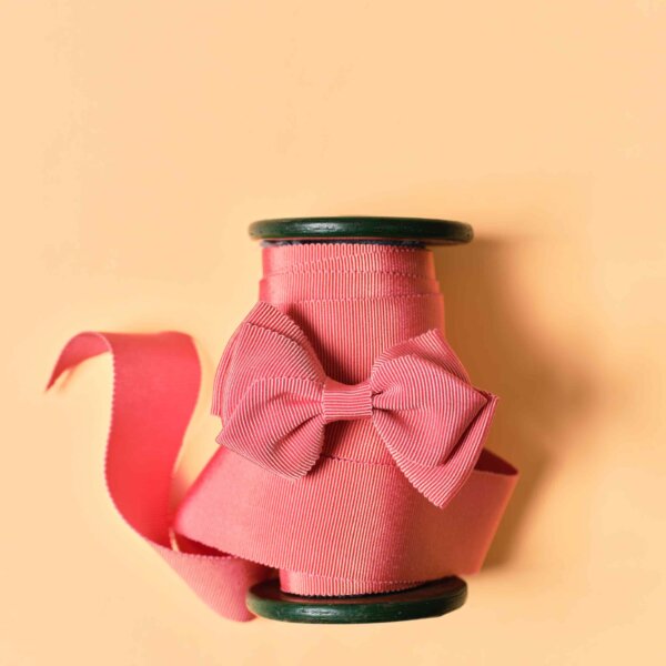 Peach gros grain on a spool, with a bow on top by Impression Originale