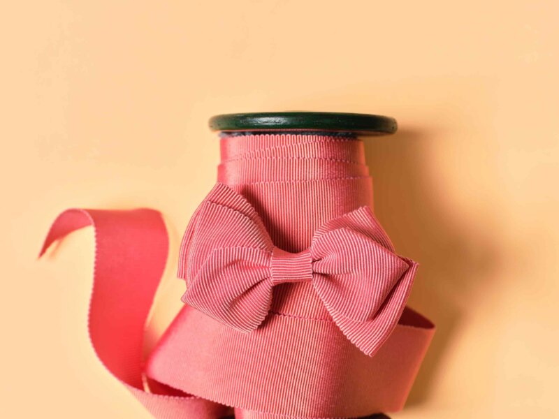 Peach gros grain on a spool, with a bow on top by Impression Originale
