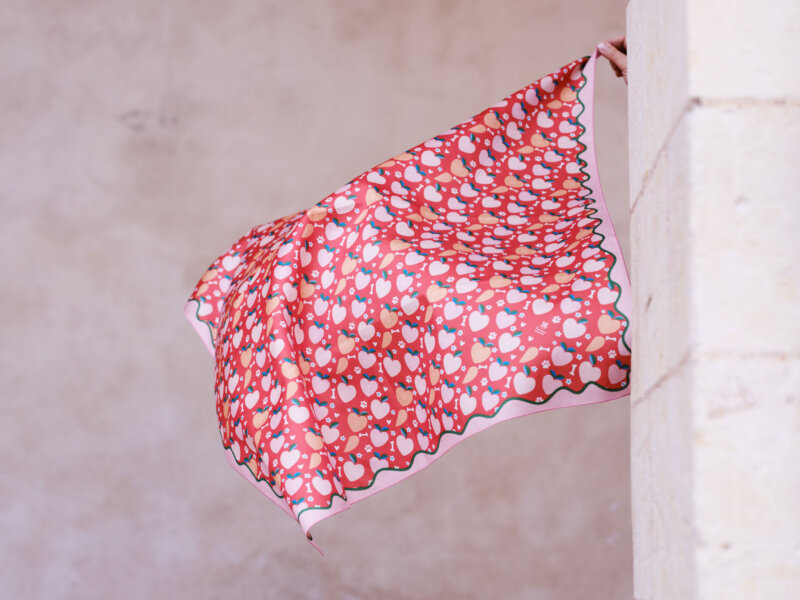Flying furoshiki with "hearts" design in a historical white stone arch background by Impression Originale