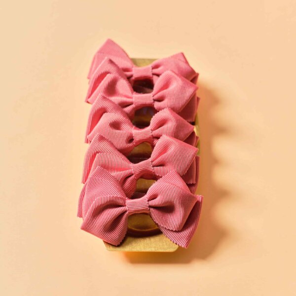 Swirl bows in gros grain, peach colour, on a brass tray by Impression Originale