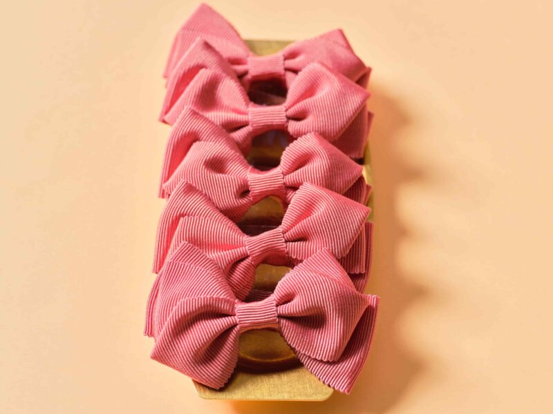 Swirl bows in gros grain, peach colour, on a brass tray by Impression Originale